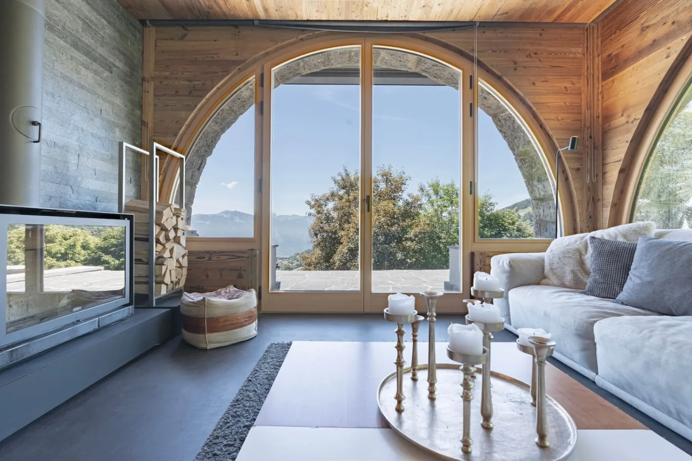 Old-wood living room with corner sofa and arched windows, apartment with hammam in Villars