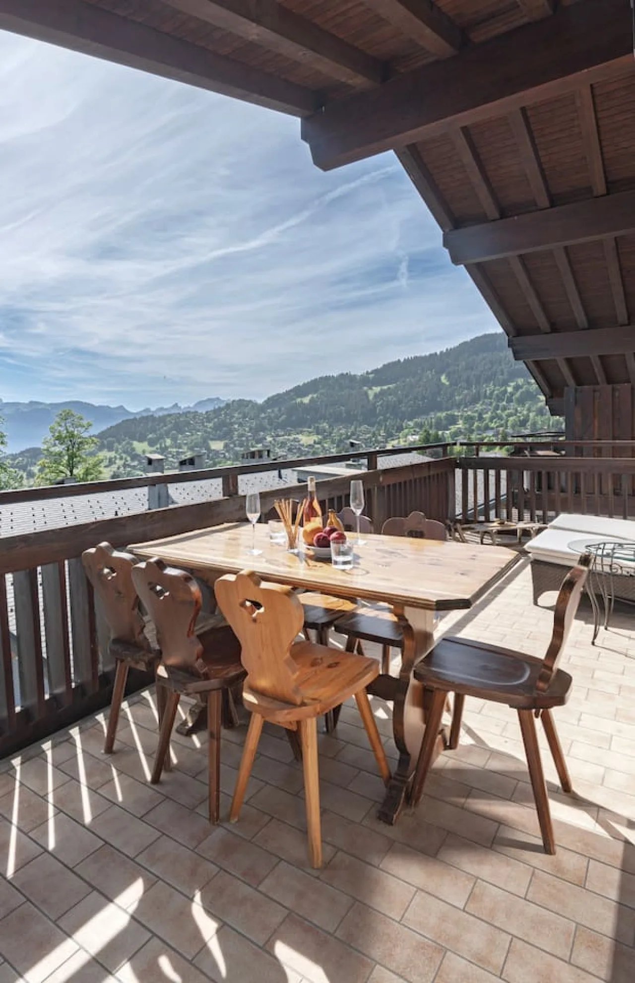 Drinks on the covered balcony facing the Vaud Alps, penthouse in Villars
