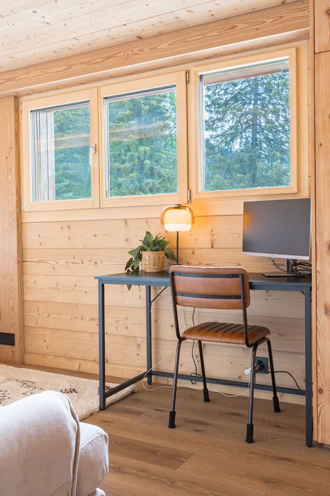 Desk corner with screen in a bedroom of the penthouse, Villars
