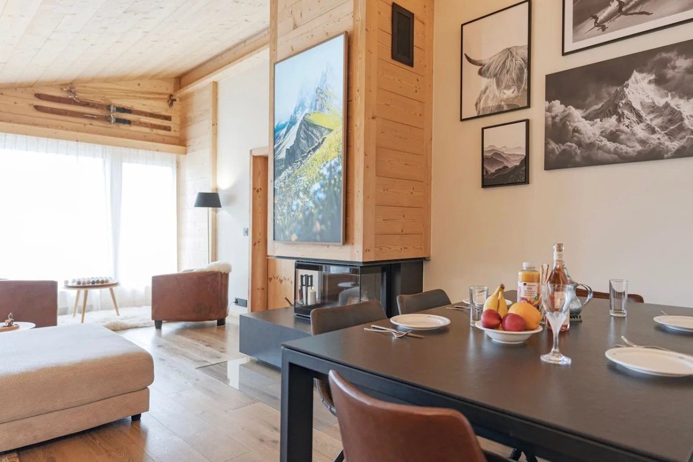 Penthouse living room with mountain paintings and large windows, Villars