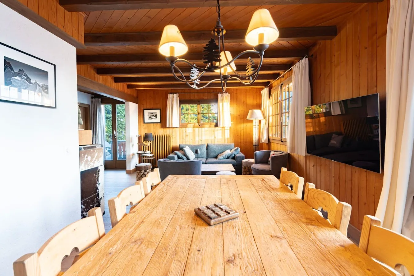 Wooden dining table for eight under the panelled ceiling of the chalet, Villars-sur-Ollon