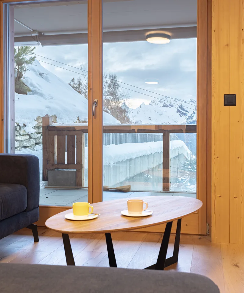 Coin repas près de la fenêtre avec vue montagne d'un appartement en gestion à Ovronnaz